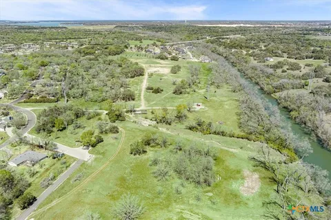 a view of a field with trees in the background