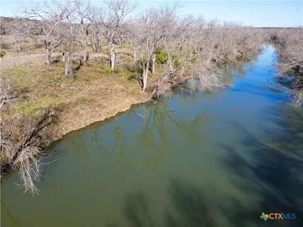 a view of a field with an ocean view