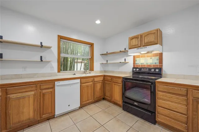 a view of a kitchen with a sink and a refrigerator