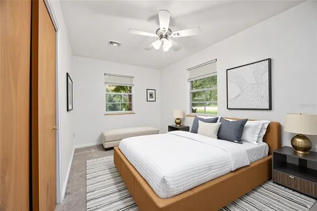 a bedroom with a large bed and a window