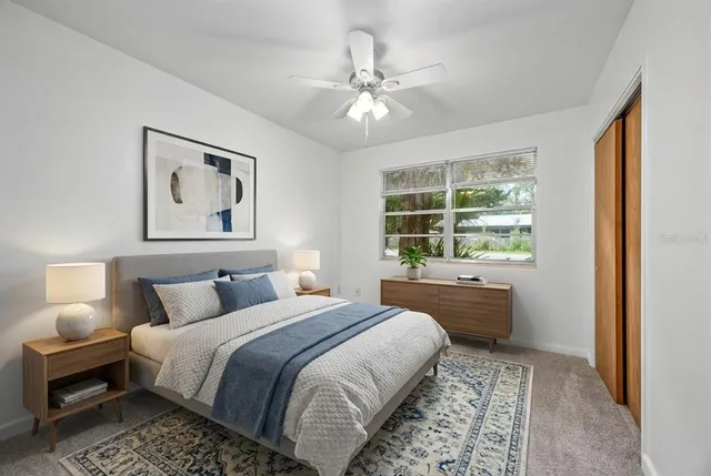 a bathroom with a sink a toilet a window and shower