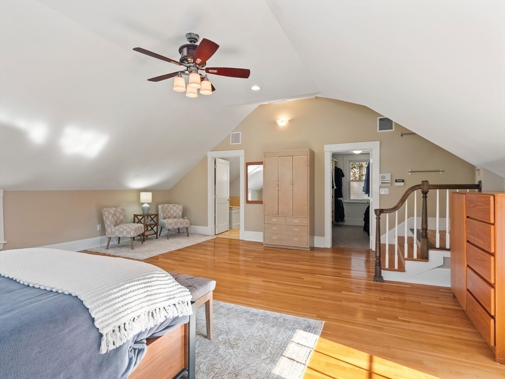 20 Maple Street Lexington, MA 02420 - Photo 19 of 36 a spacious bedroom with a bed and a chandelier