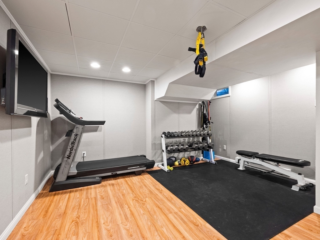 20 Maple Street Lexington, MA 02420 - Photo 31 of 36 a room with gym equipment and wooden floor