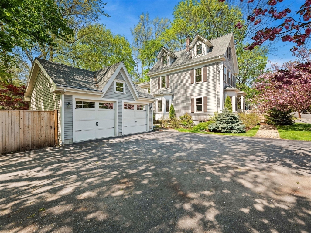 20 Maple Street Lexington, MA 02420 - Photo 36 of 36 a front view of a house with a yard and a garage