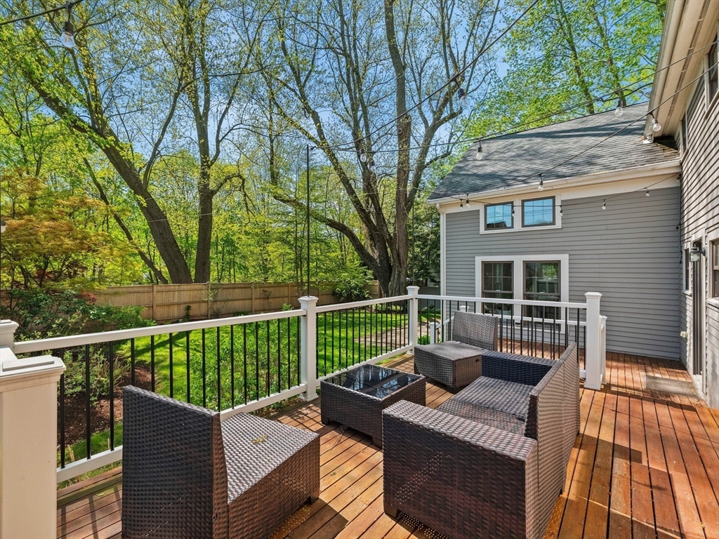 20 Maple Street Lexington, MA 02420 - Photo 8 of 36 a view of a deck with couches and wooden floor