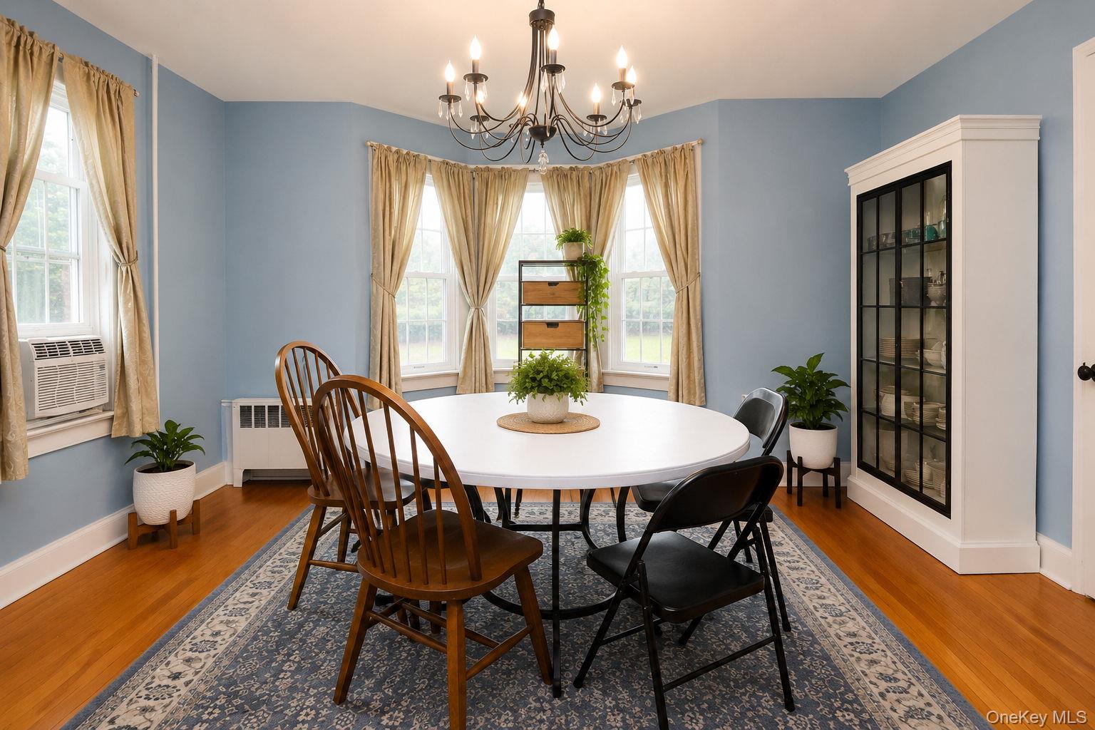 340 Dunn Road Montgomery, NY 12549 - Photo 13 of 34 Formal dinning room with chandelier lighting, wood floors and china cabinet