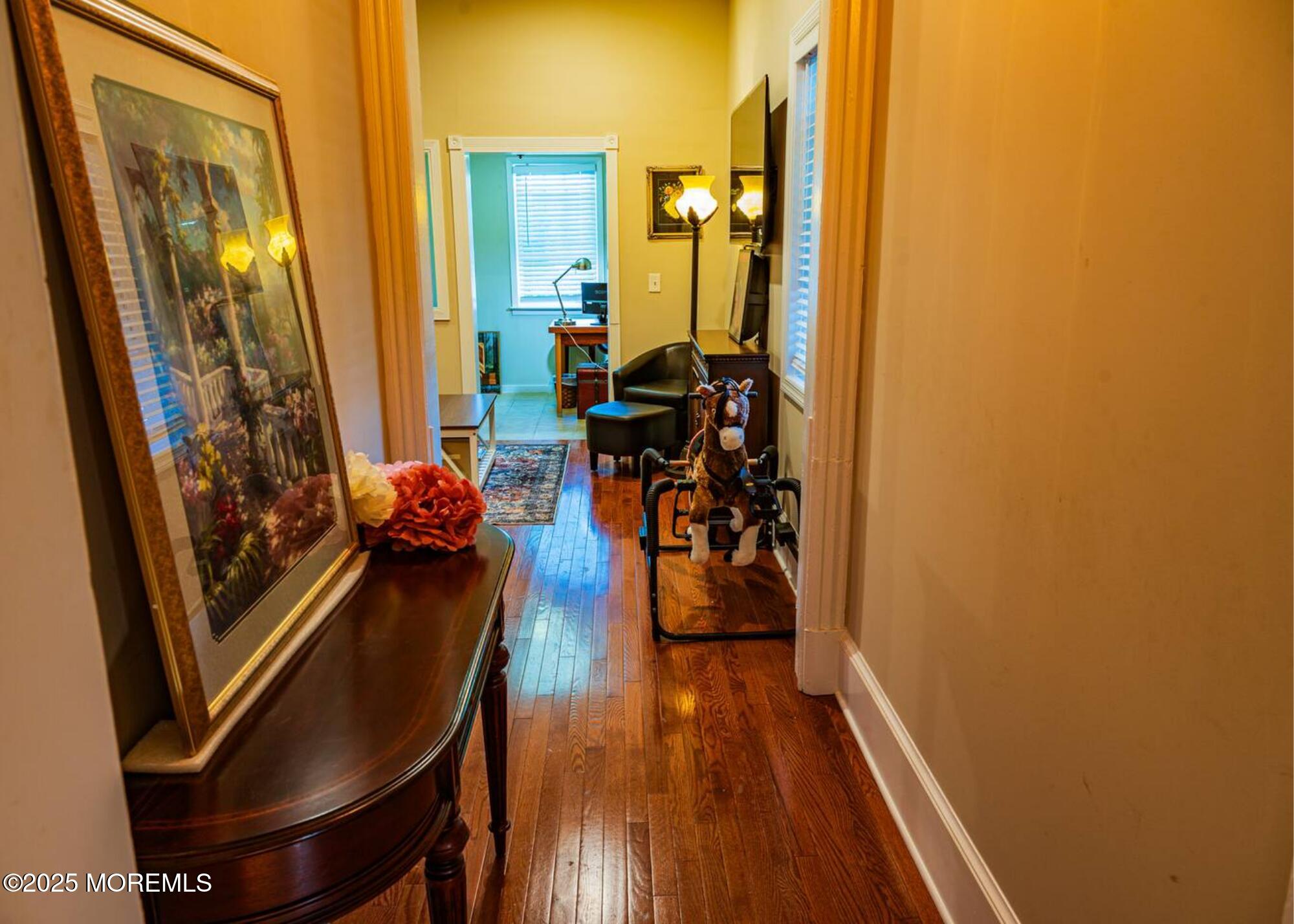 70S Bath Avenue, Unit 1 Long Branch, NJ 07740 - Photo 14 of 19 a view of a livingroom with furniture and hardwood floor