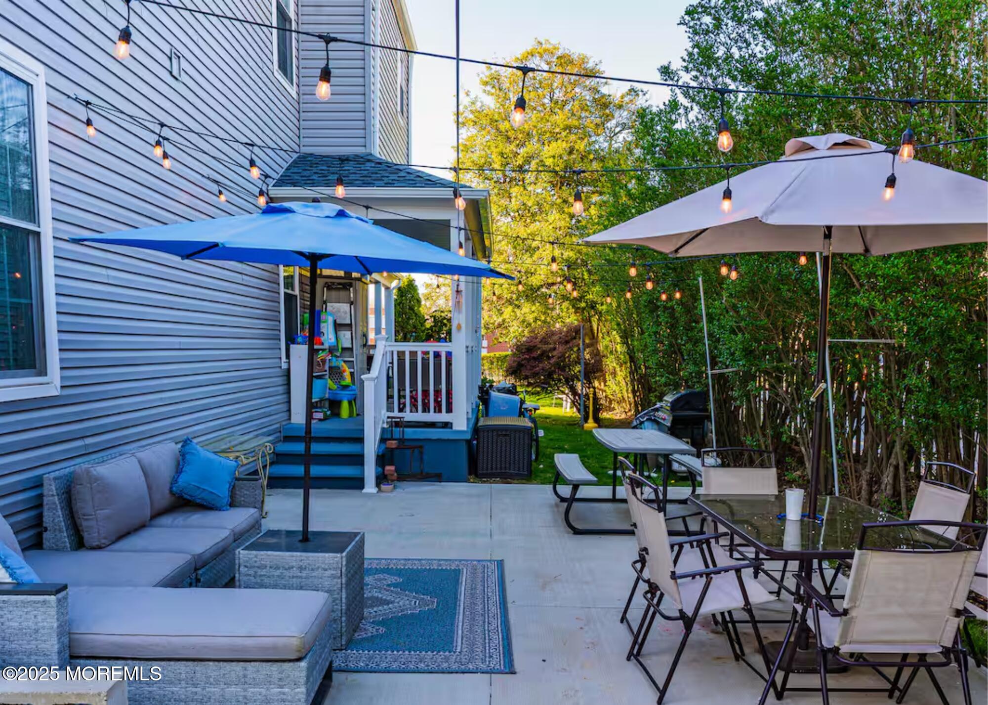 70S Bath Avenue, Unit 1 Long Branch, NJ 07740 - Photo 6 of 19 a view of a patio with a table and chairs under an umbrella