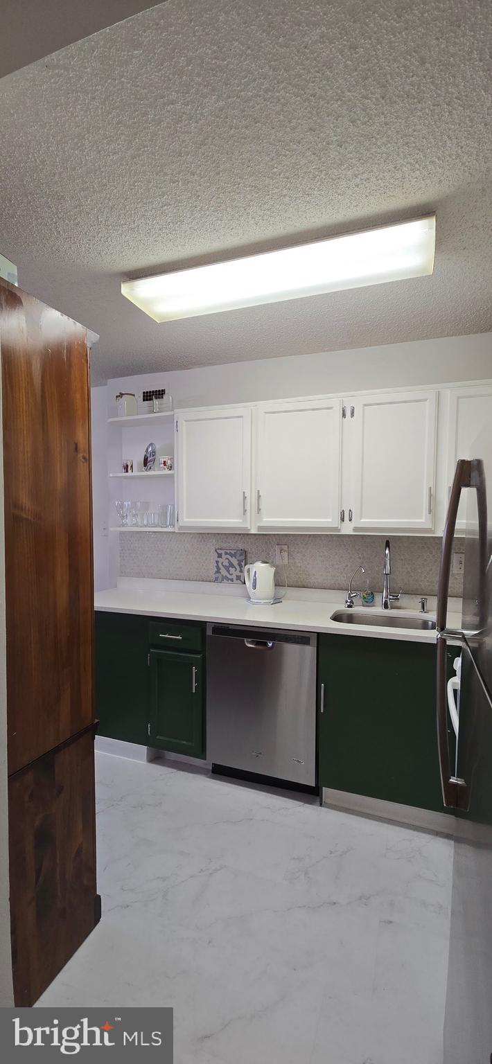 5225 Pooks Hill Road, Unit 703N Bethesda, MD 20814 - Photo 12 of 57 a kitchen with stainless steel appliances granite countertop a refrigerator and a sink