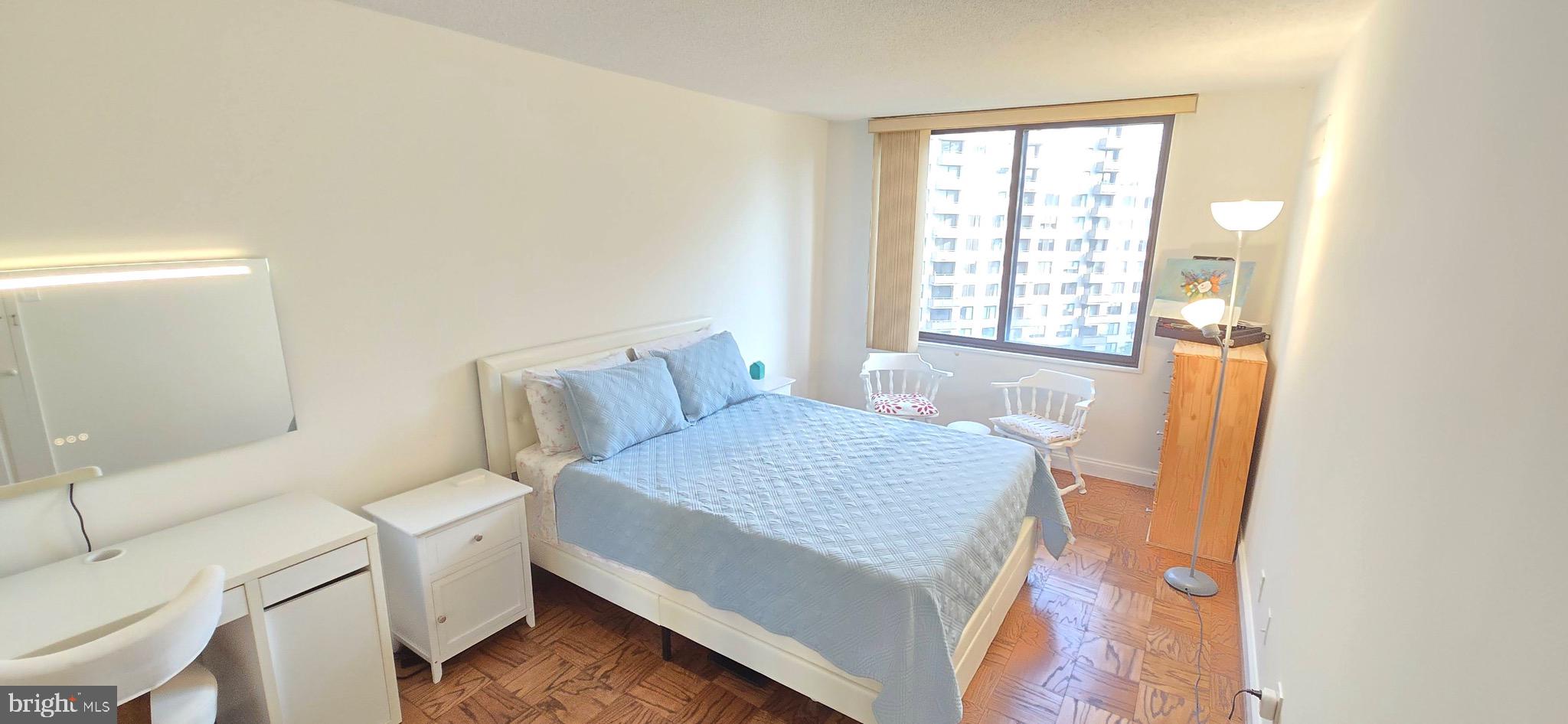 5225 Pooks Hill Road, Unit 703N Bethesda, MD 20814 - Photo 17 of 57 a room with a bed and a table