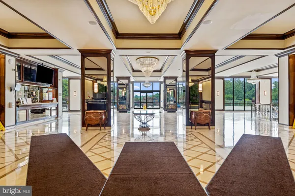 a lobby with furniture and large windows