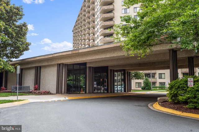 a lobby with furniture and large windows