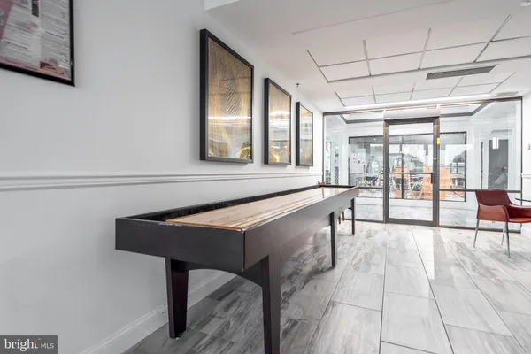 a hallway with furniture and a flat screen tv