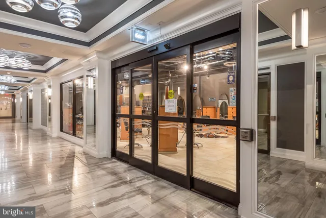 a view of a hallway with a table and chairs