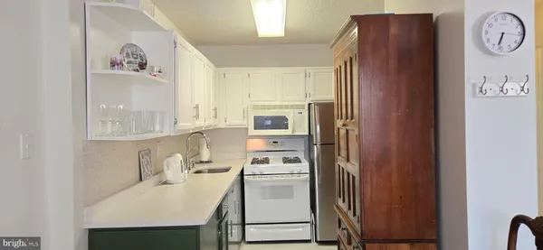a kitchen with a refrigerator and a stove