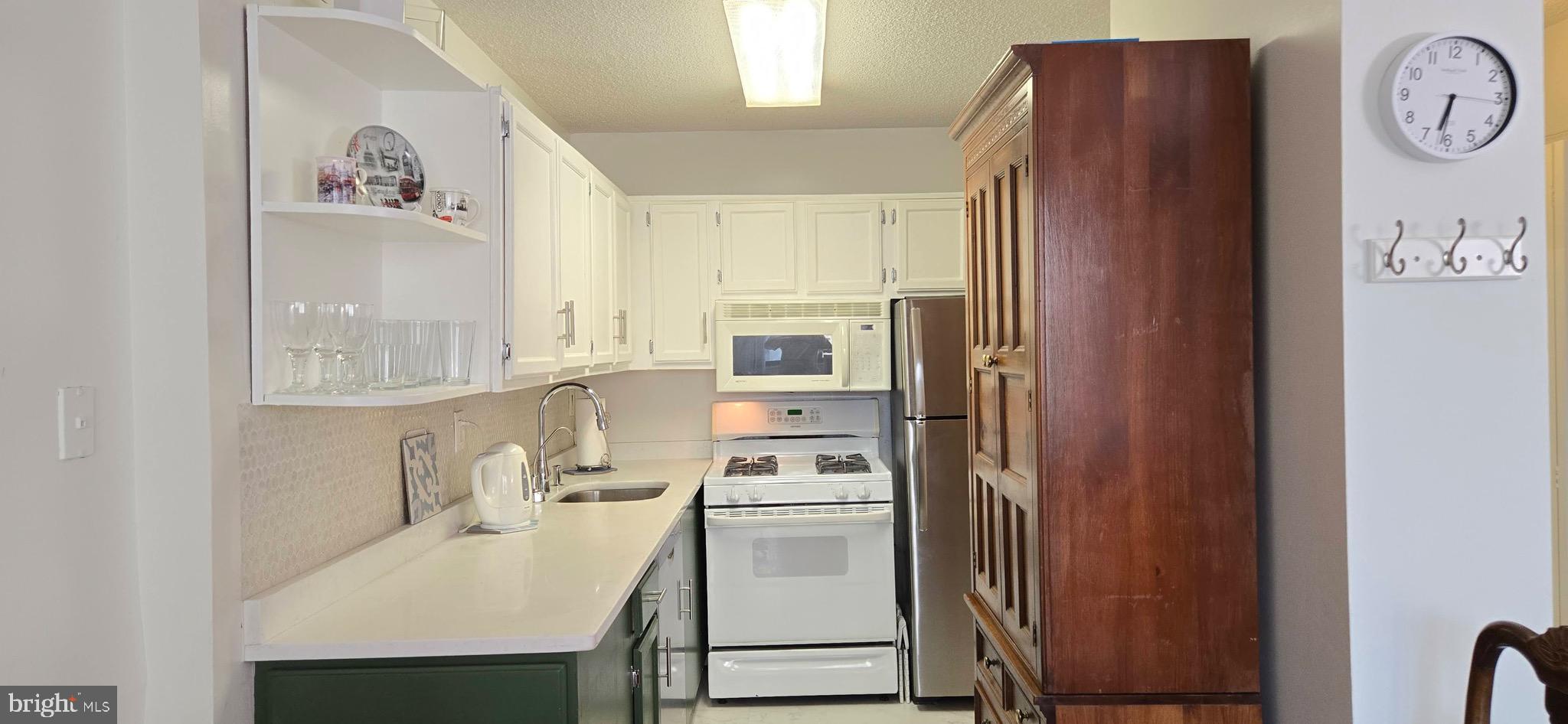 5225 Pooks Hill Road, Unit 703N Bethesda, MD 20814 - Photo 3 of 57 a kitchen with a refrigerator and a stove