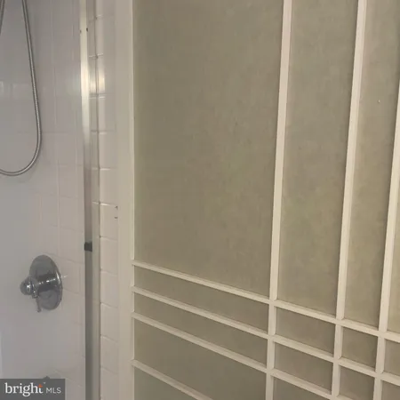 a bathroom with a glass shower door