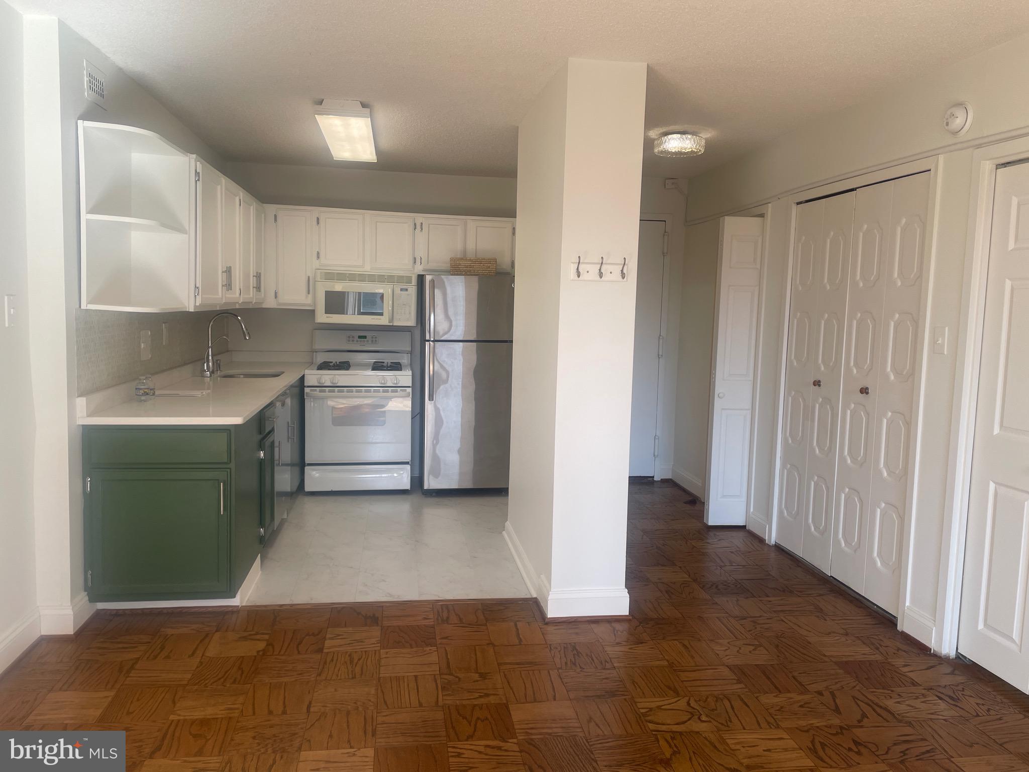 5225 Pooks Hill Road, Unit 703N Bethesda, MD 20814 - Photo 9 of 55 a kitchen with refrigerator and cabinets