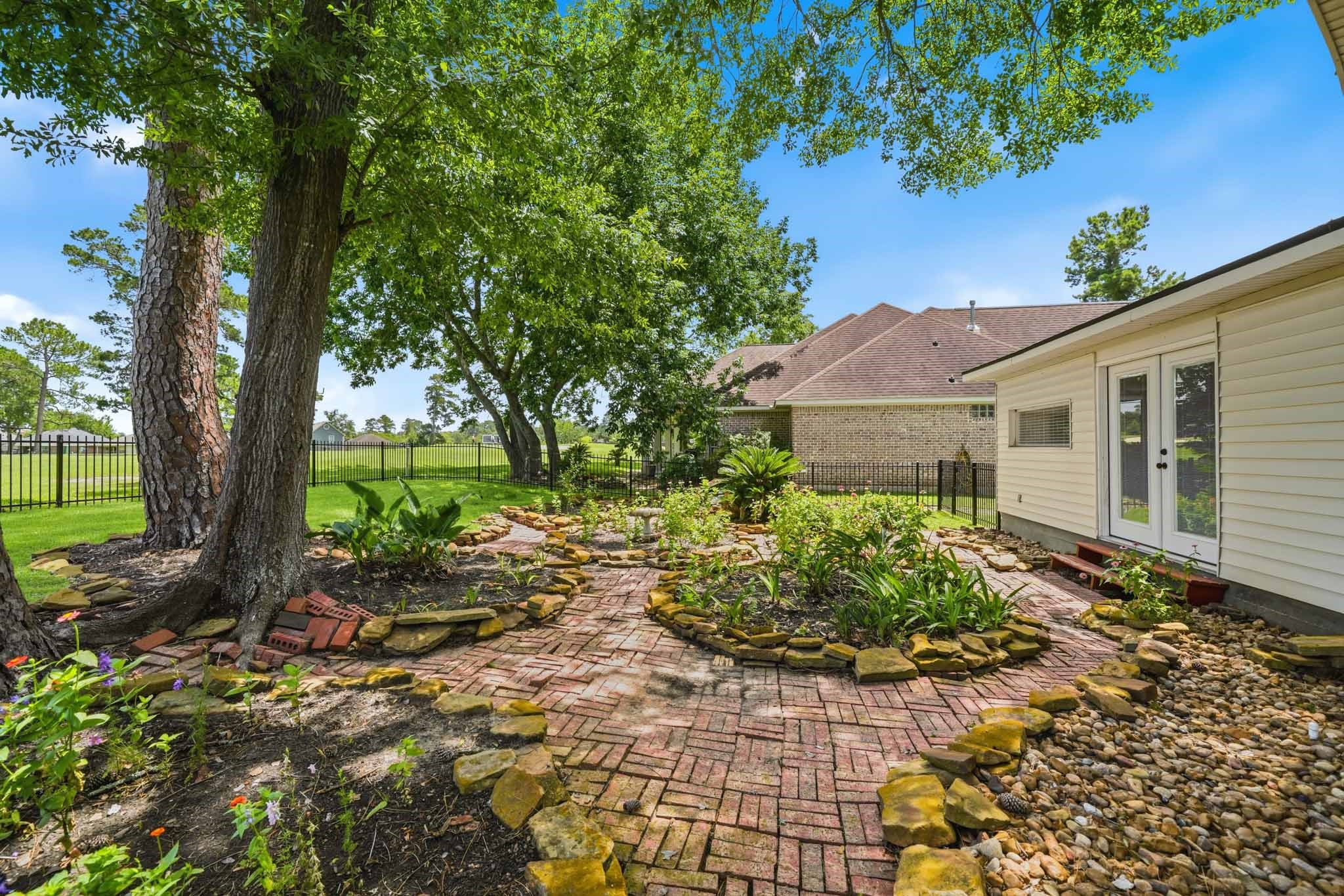 79 Summers Wind Street Conroe, TX 77356 - Photo 41 of 45 a front view of a house with garden
