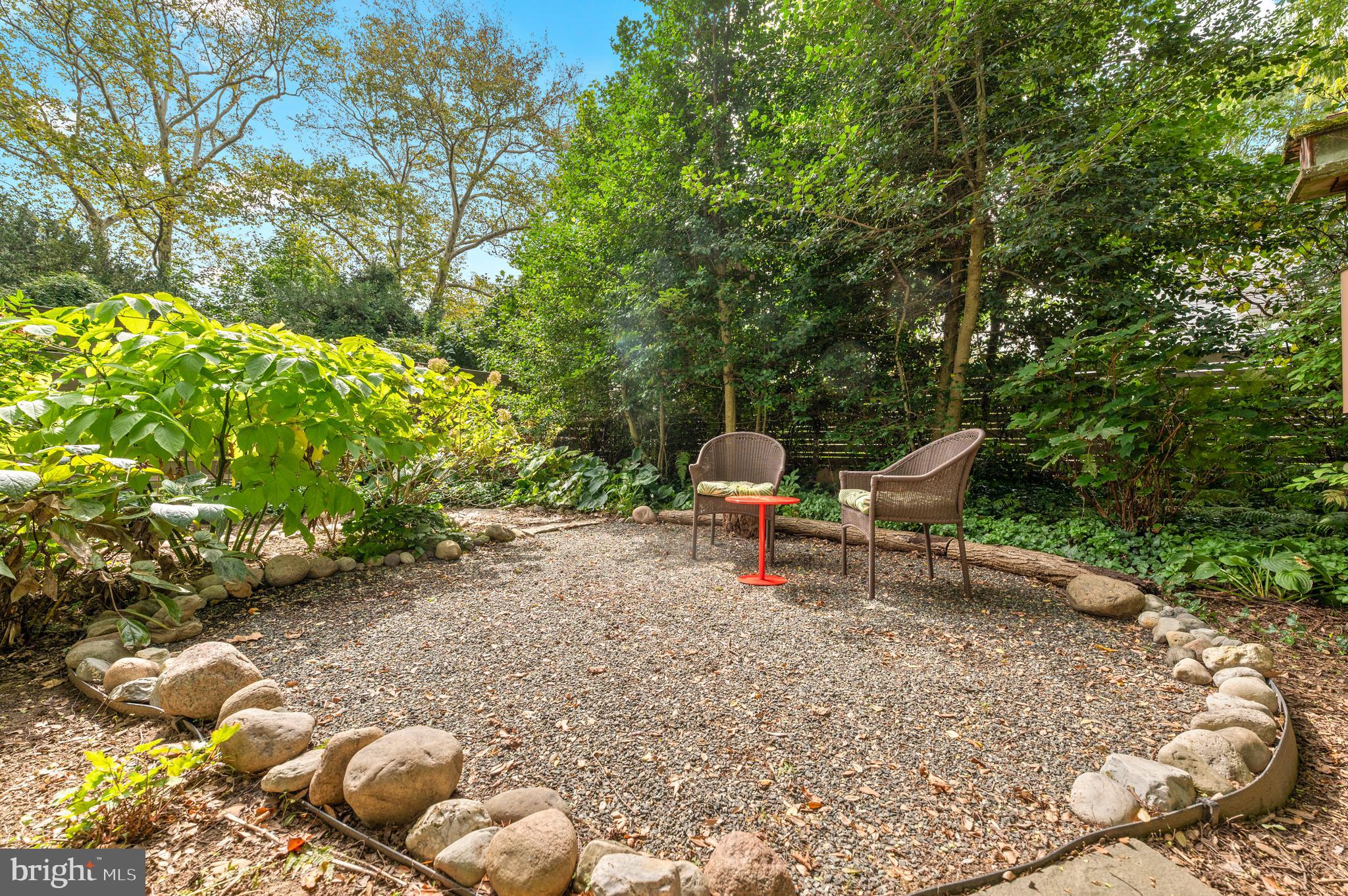 414 Mcclenaghan Mill Road Wynnewood, PA 19096 - Photo 7 of 43 a view of a backyard with lawn chairs and a large tree