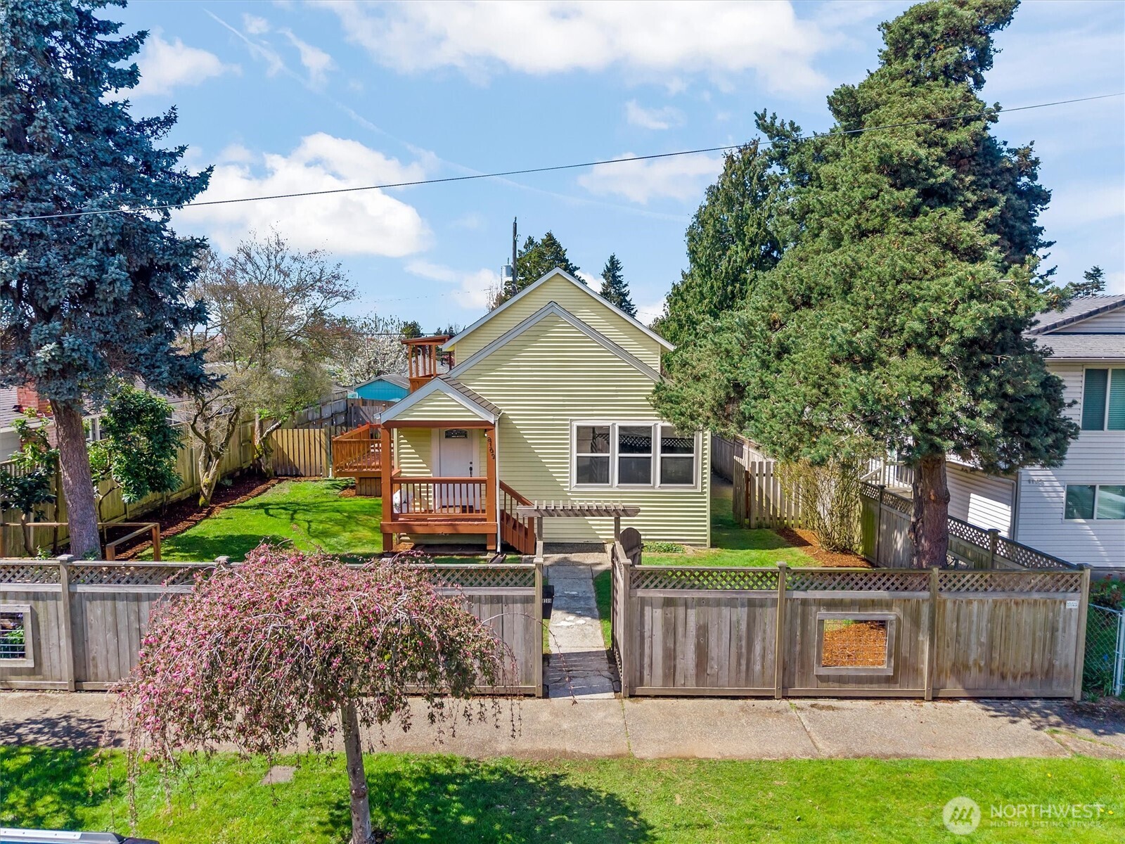 8109 15th Avenue Southwest Seattle, WA 98106 - Photo 1 of 39 a front view of a house with a yard