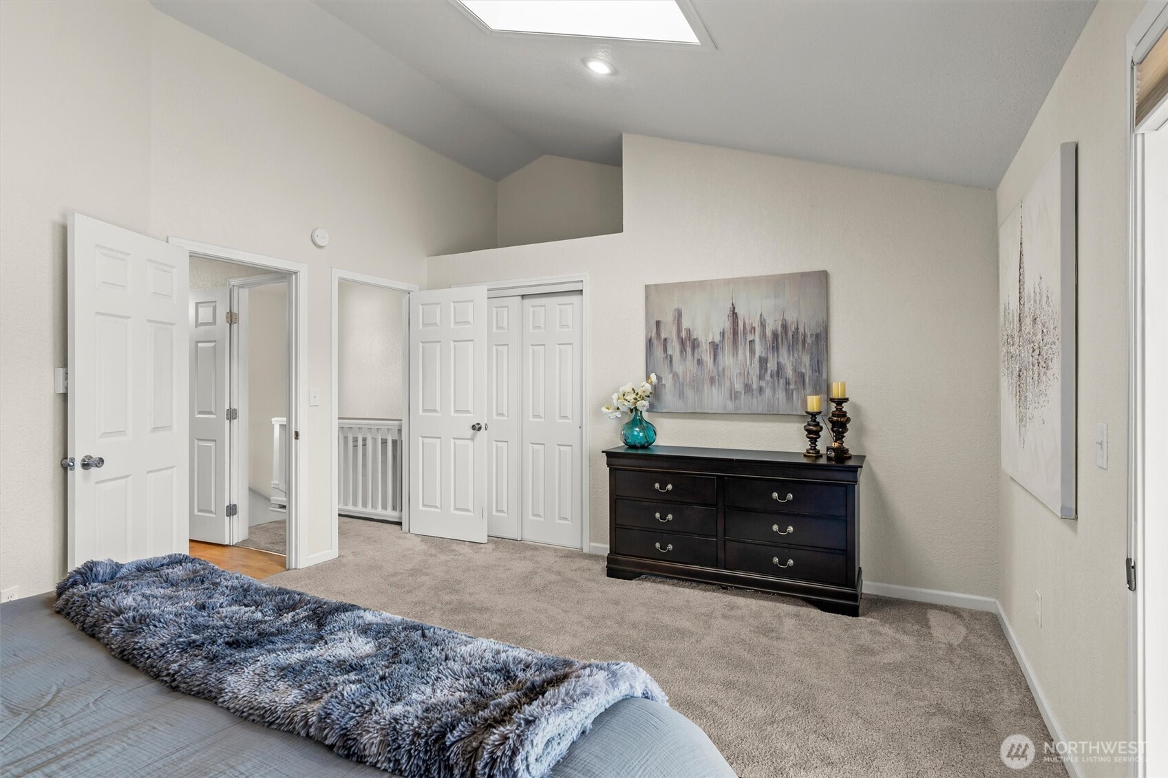 8109 15th Avenue Southwest Seattle, WA 98106 - Photo 15 of 39 a spacious bedroom with a bed and painting on the wall