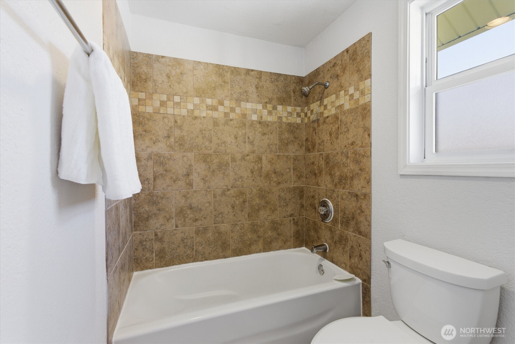 8109 15th Avenue Southwest Seattle, WA 98106 - Photo 17 of 39 a bathroom with a toilet and a bathtub