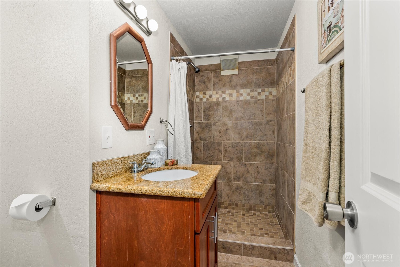 8109 15th Avenue Southwest Seattle, WA 98106 - Photo 30 of 39 a bathroom with a sink and a mirror