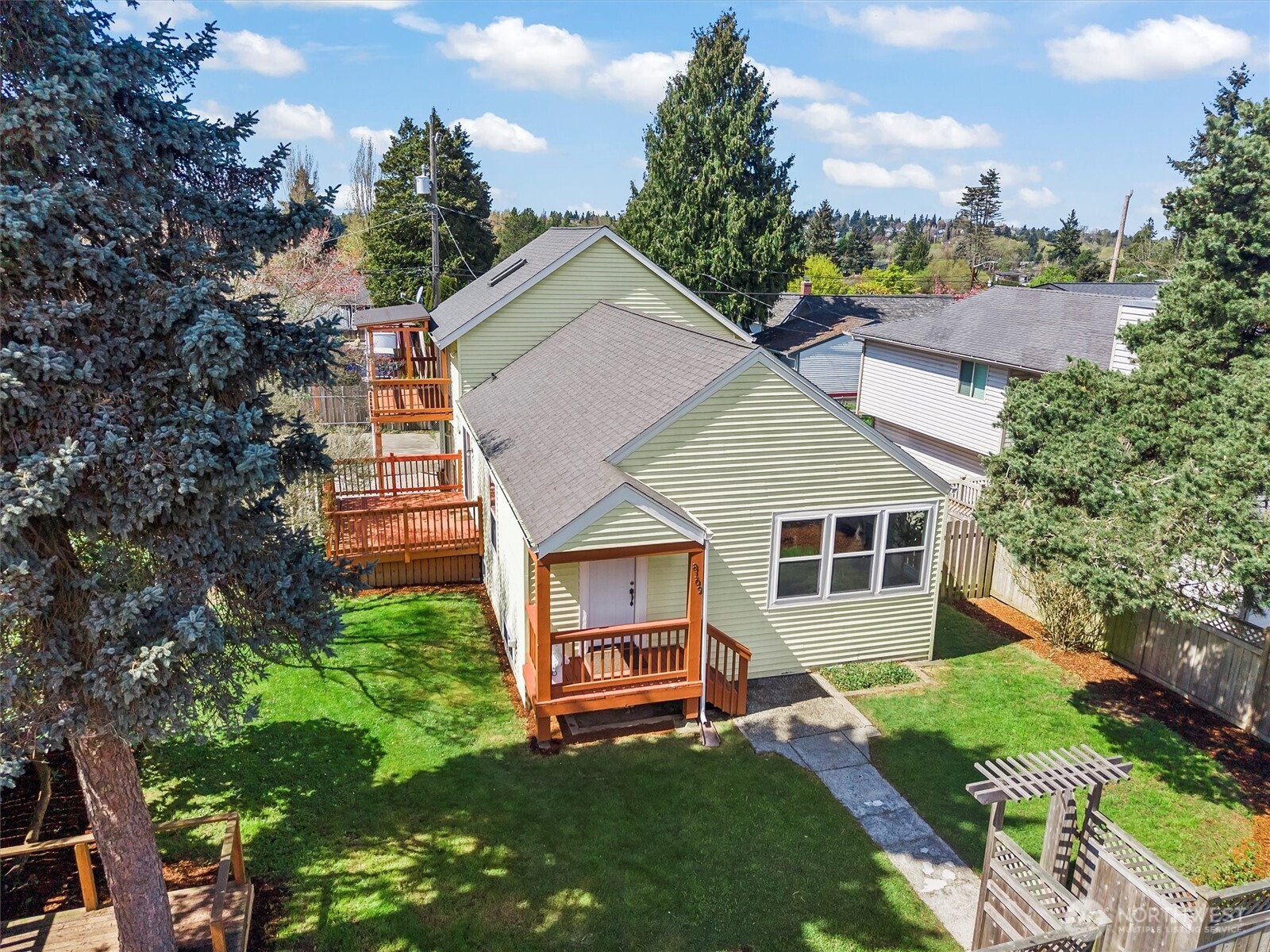 8109 15th Avenue Southwest Seattle, WA 98106 - Photo 37 of 39 a view of a house with a yard plants and large tree