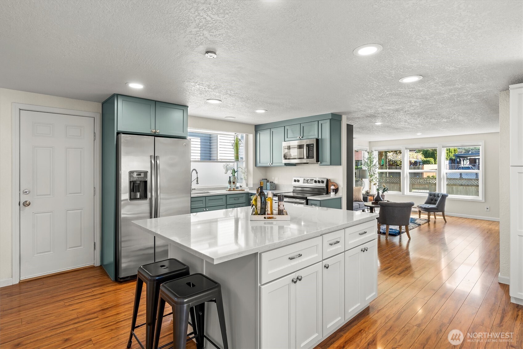 8109 15th Avenue Southwest Seattle, WA 98106 - Photo 7 of 39 a kitchen with counter space dining table and wooden floor