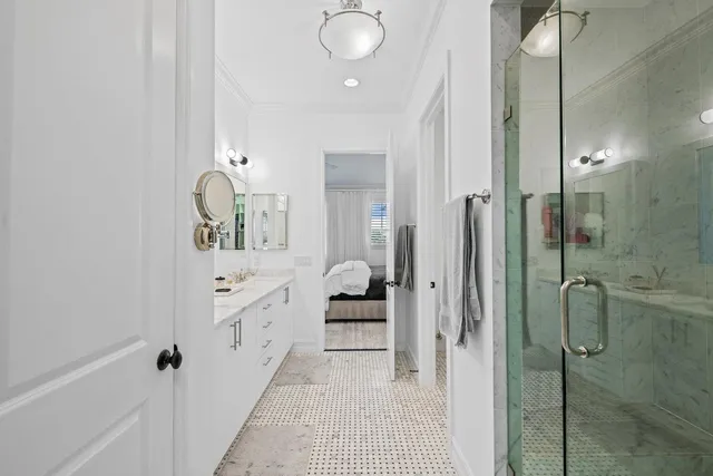 a bathroom with a double vanity sink and mirror with shower