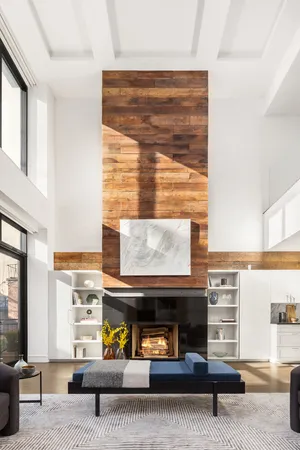 a living room with furniture fireplace and a large window