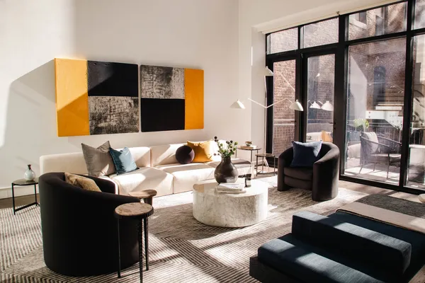 a living room with furniture and a lamp