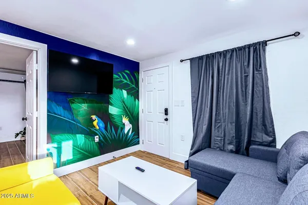 a living room with furniture and a flat screen tv