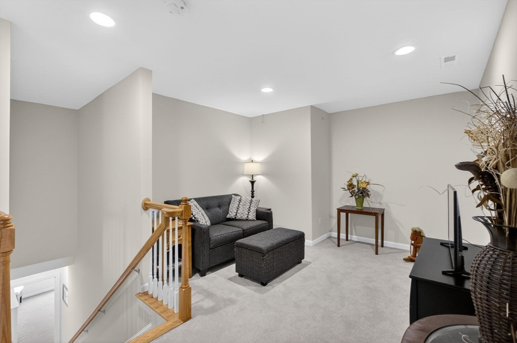 87 Shannon Way, Unit 86 Upton, MA 01568 - Photo 24 of 36 a living room with furniture and a lamp