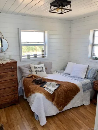 a bedroom with a bed and window