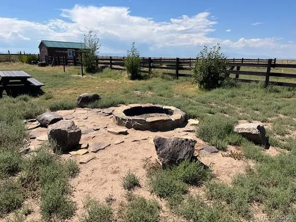 a view of a backyard with table and chairs