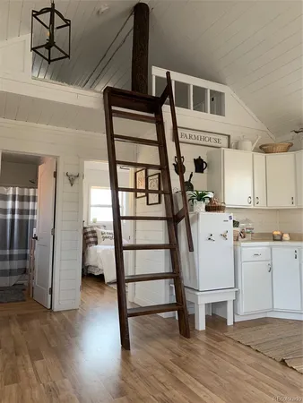 a view of kitchen with cabinets and wooden floor