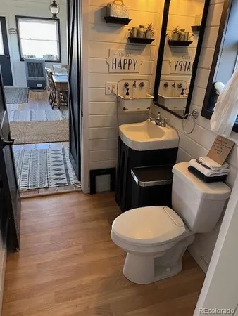 a bathroom with a toilet a sink and mirror