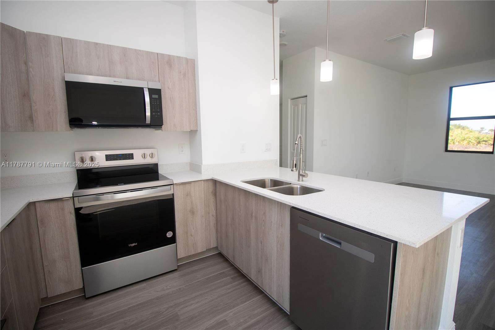 9023 Meadow Circle LaBelle, FL 33935 - Photo 11 of 35 a kitchen with a sink and a microwave