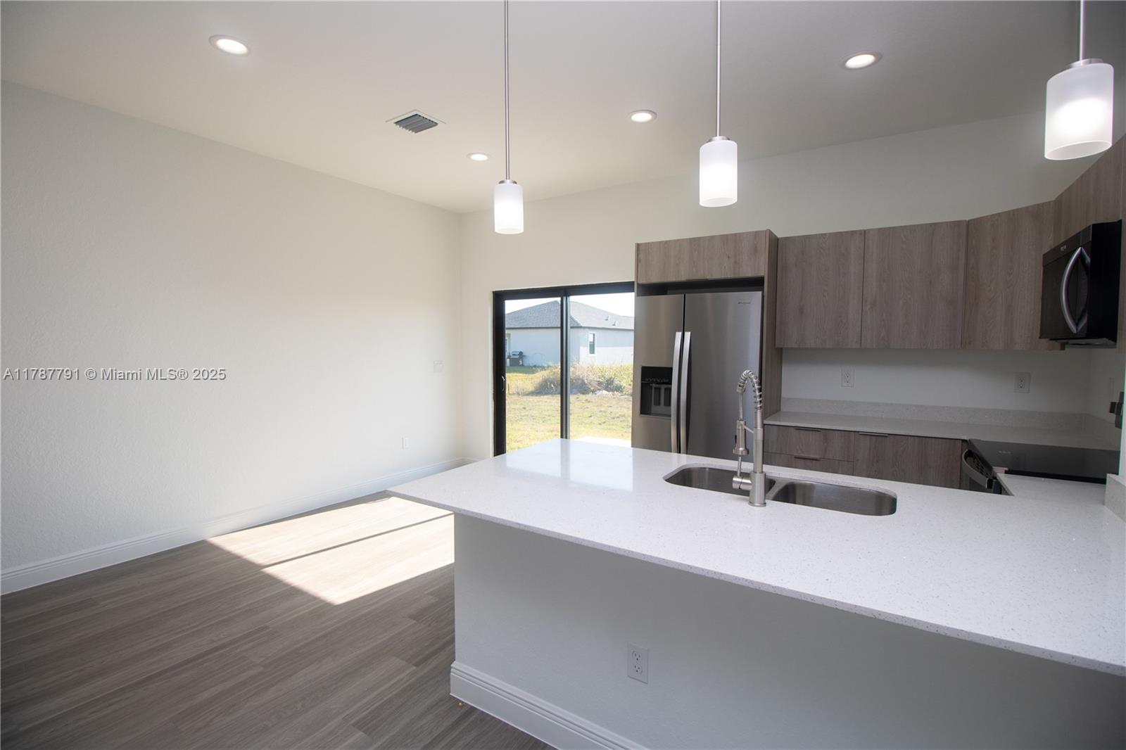 9023 Meadow Circle LaBelle, FL 33935 - Photo 13 of 35 a view of a kitchen with a sink and a large window