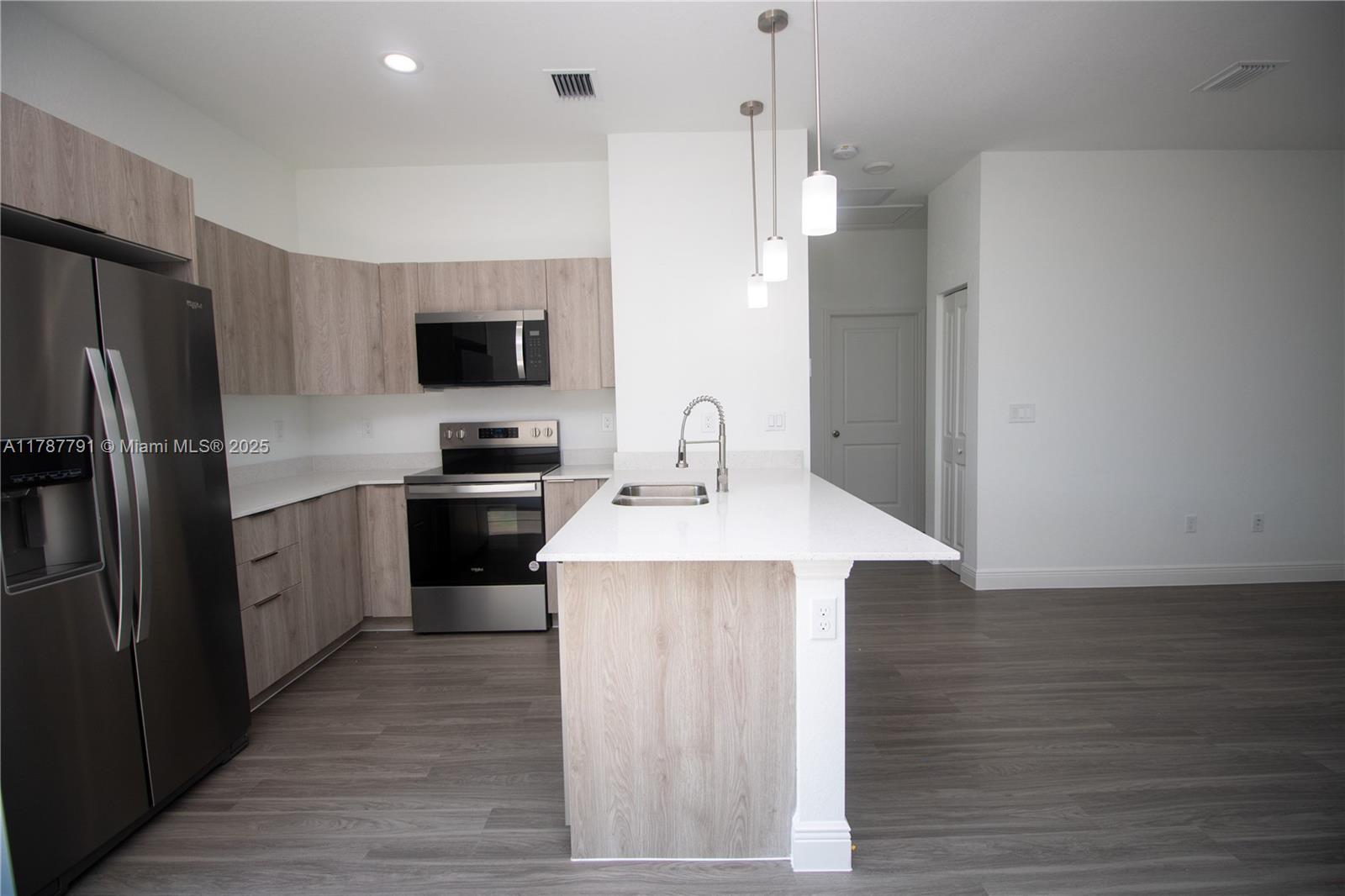 9023 Meadow Circle LaBelle, FL 33935 - Photo 10 of 35 a kitchen with kitchen island a sink stainless steel appliances and cabinets