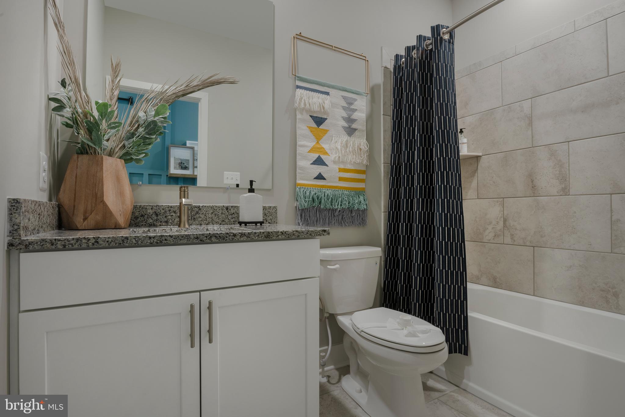 35135 Kindleton Lane Lewes, DE 19958 - Photo 12 of 16 a bathroom with a granite countertop sink toilet and shower