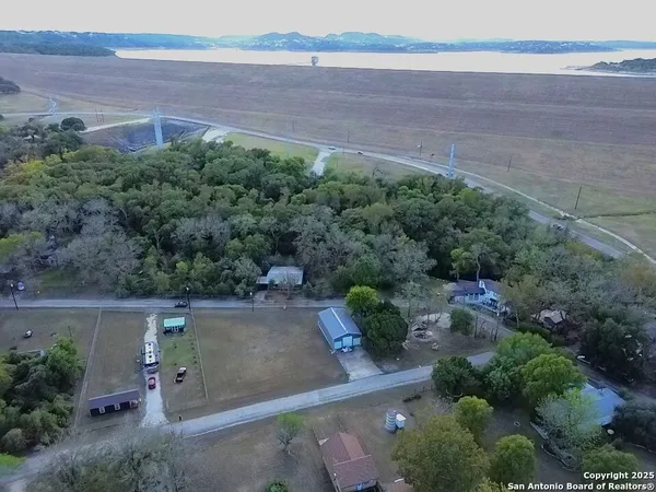 an aerial view of a house with a yard and a large parking space