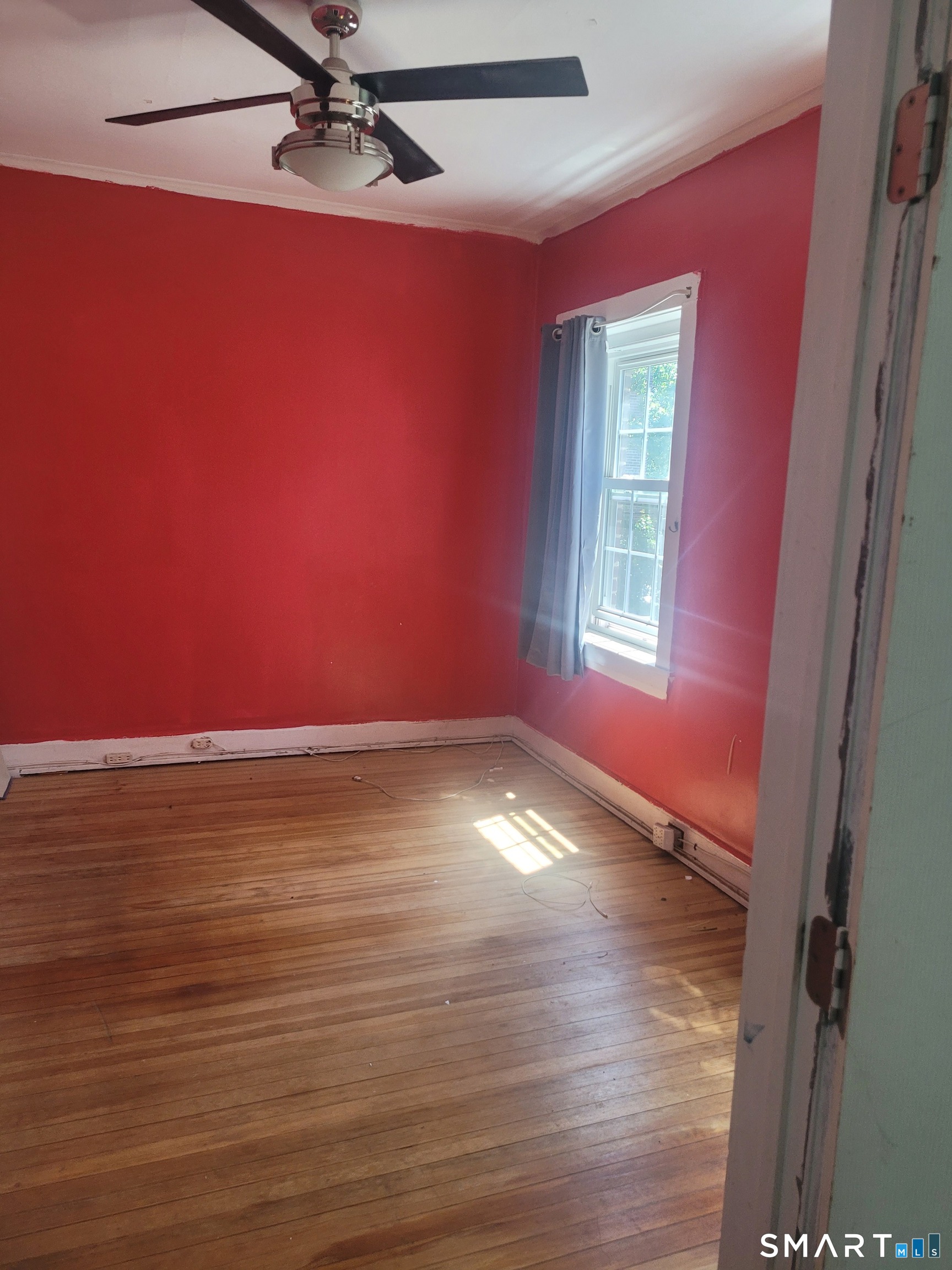 606 Wilmot Avenue, Unit 4 Bridgeport, CT 06607 - Photo 8 of 16 a view of empty room with window and wooden floor