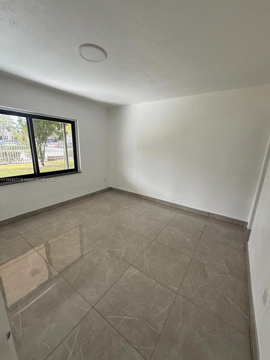 351 East 4th Avenue, Unit 4 Hialeah, FL 33010 - Photo 14 of 19 an empty room with windows and closet