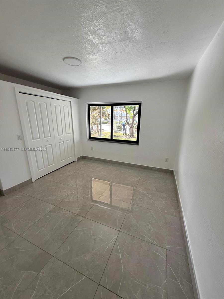351 East 4th Avenue, Unit 4 Hialeah, FL 33010 - Photo 18 of 19 an empty room with windows