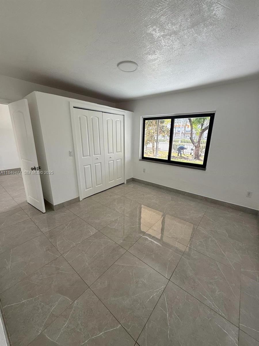 351 East 4th Avenue, Unit 4 Hialeah, FL 33010 - Photo 19 of 19 an empty room with windows and entrance