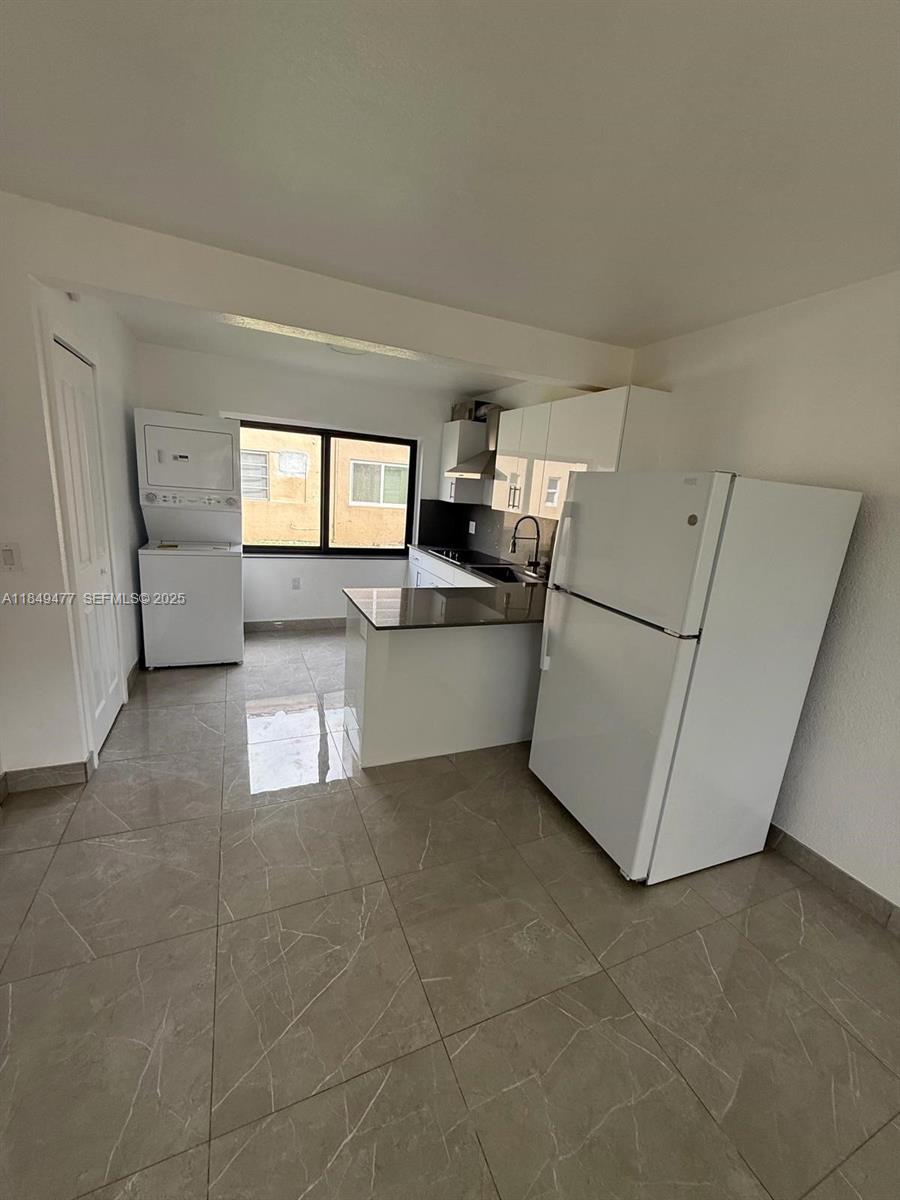 351 East 4th Avenue, Unit 4 Hialeah, FL 33010 - Photo 3 of 19 a kitchen with a refrigerator and white cabinets