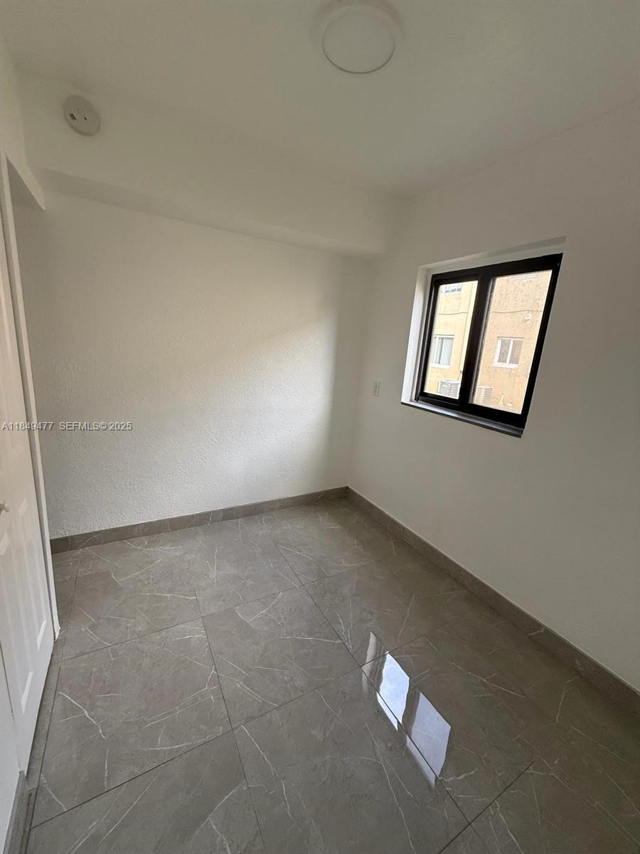 351 East 4th Avenue, Unit 4 Hialeah, FL 33010 - Photo 5 of 19 an empty room with windows